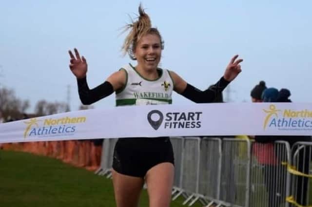 All smiles as Wakefield Harriers runner Abbey Brooke crosses the finishing line to win the North of England U20 Cross Country title.