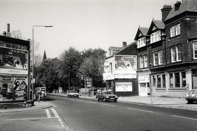 Headingley Lane looking north-west. The junction with Victoria Road is on the left and that with Regent Park Avenue on the right. Businesses on the right include the J.C.C. Driving Academy.