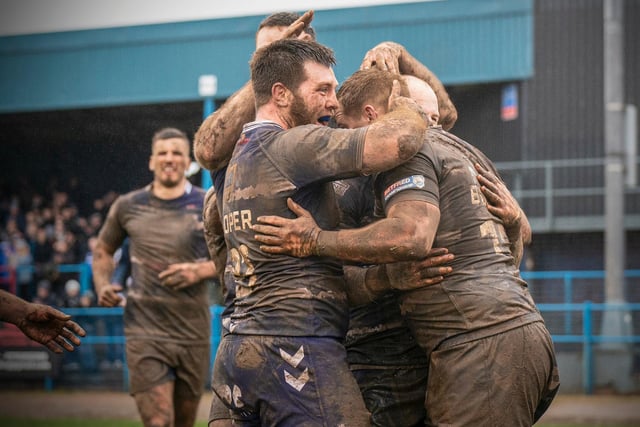 Jack Bussey celebrates his match sealing try with Featherstone Rovers teammates. Picture: Dec Hayes