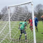 Wakefield Athletic striker Danny Young sees his towering header sail narrowly wide.