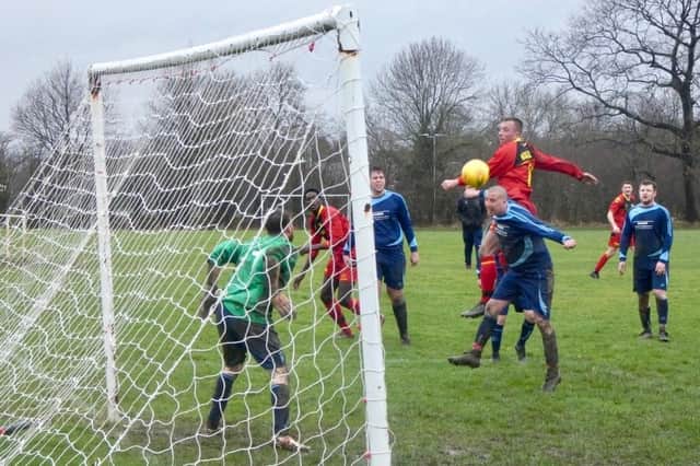 Wakefield Athletic striker Danny Young sees his towering header sail narrowly wide.