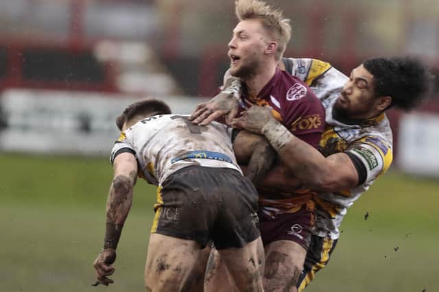 Batley Bulldogs' James Meadows is all wrapped up by York City Knights' Matty Marsh and Pauli Pauli. Picture: Neville Wright