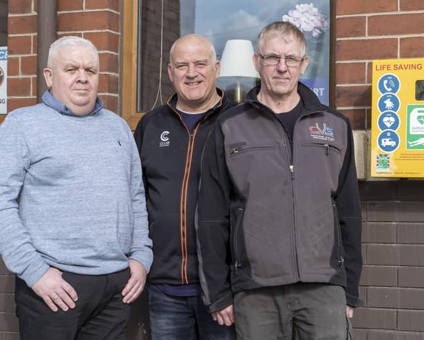campaigners: The defibrillator outside The Eagle pub on Methley Road in Castleford, from left: Tony Carlin, Darren Moore and Terry Bilsbrough.