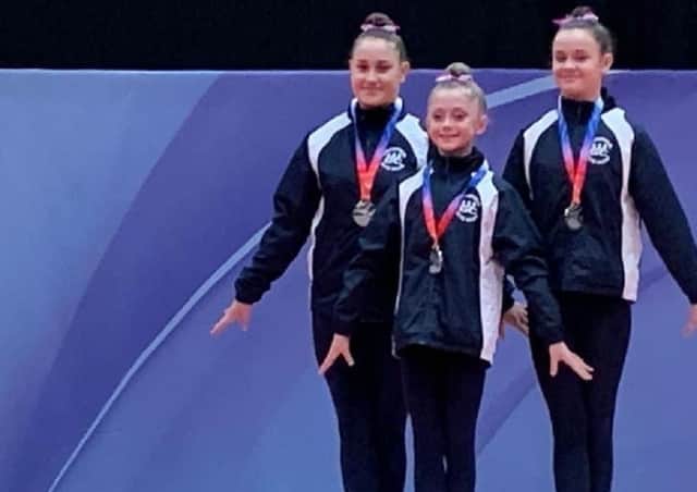 Wakefield Gym Club's Bethany Butterfield, Lucy Vause and Georgia Robinson stand on the podium after winning a silver medal at the British Championships.