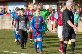 Emley AFC juniors walk out with the senior players ahead of the game with Barton Town. Picture: Mark Parsons