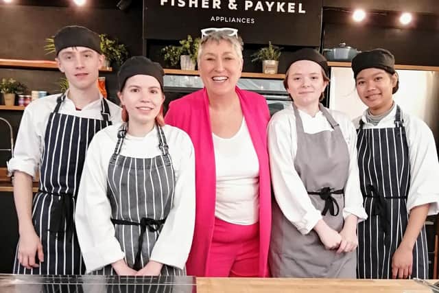 Karen on stage with catering students from Wakefield College