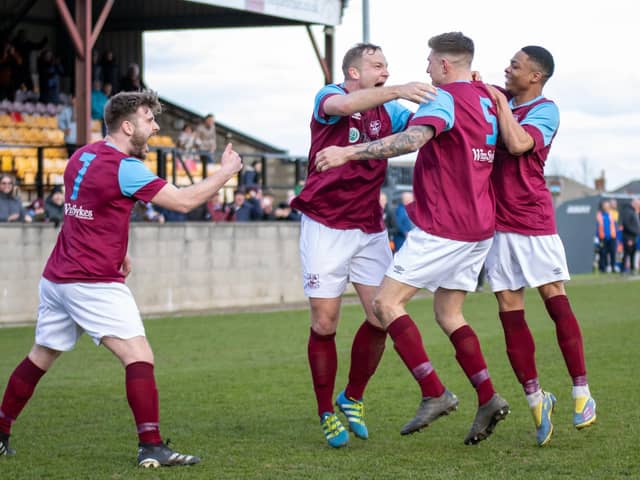 Sam Pashley celebrates his winning goal with Emley AFC teammates. Picture: Mark Parsons