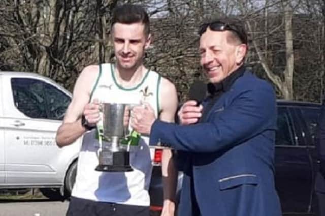 Mark Bostock received his trophy as Wakefield Harriers road race champion from  the first Wakefield Hospice 10k winner Mark Ridgway.