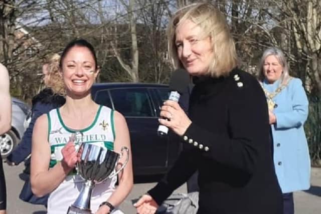 Helen Beck received her trophy for becoming the Wakefield Harriers road race champion their trophies from the first Hospice 10k race organiser Maggie Still.