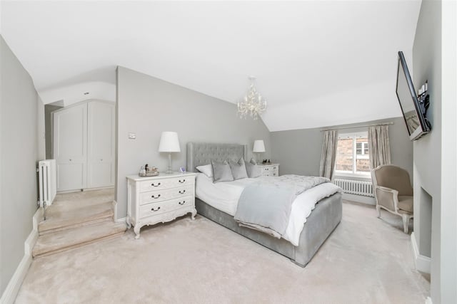 This beautiful principal bedroom suite is tastefully decorated and boasts a cast iron fireplace with a stone cobbled hearth.