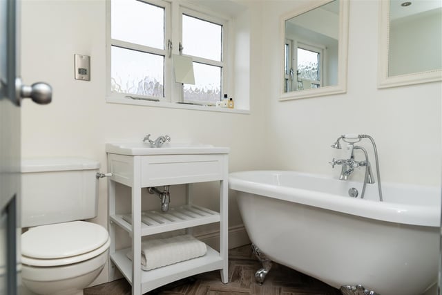 The house bathroom features a fabulous roll top claw foot double-ended bath with shower head mixer tap.
