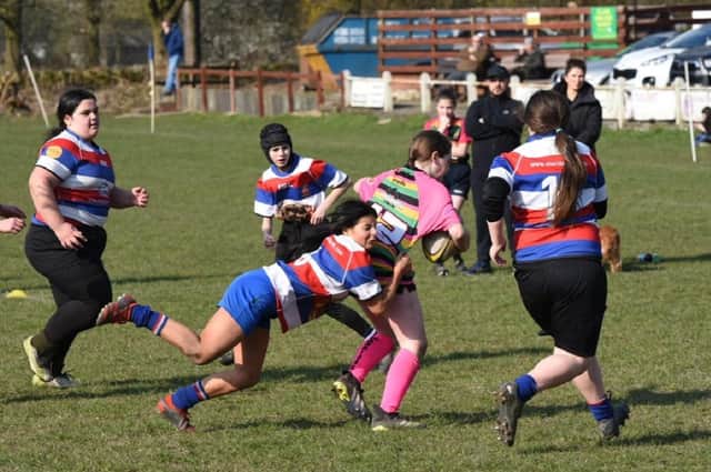 Kate Rowlinson tackled effectively in Castleford RUFC Girls U13s’ game against Littleborough. Picture: Daniel Rowlinson