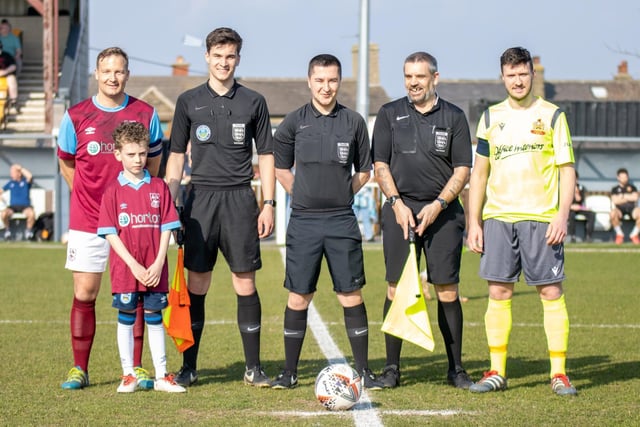 The Emley and Silsden captains line-up with the officials and match day mascot ahead of the Toolstation NCE Premier League game. Picture: Mark Parsons