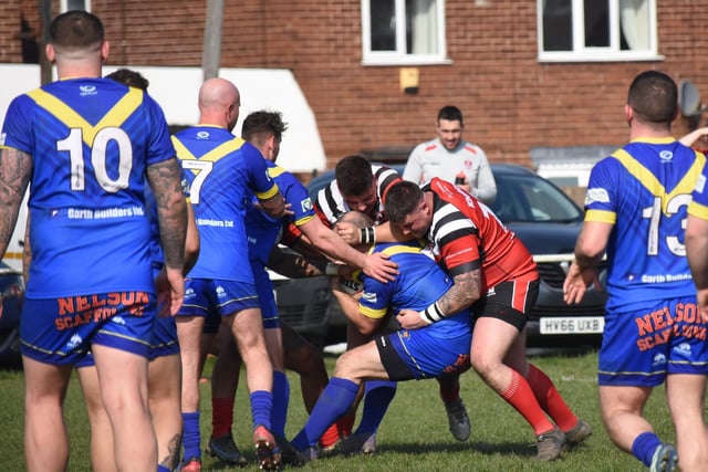 A Dudley Hill player is wrapped up by Normanton Knights tacklers. Picture: Rob Hare