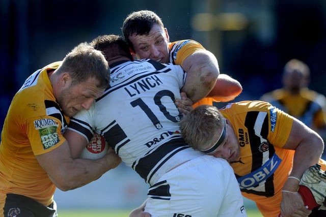 Castleford players combine to halt Andy Lynch - a Hull FC player in 2012 - in the Super League game that saw some improvement from the Tigers and brought about a vote of confidence from the board in head coach Ian Millward.