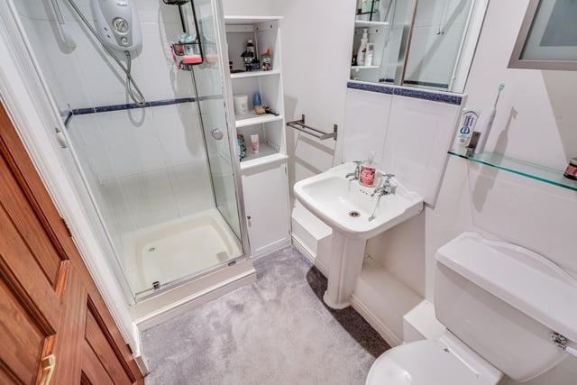A corner shower cubicle is a feature of this en suite.