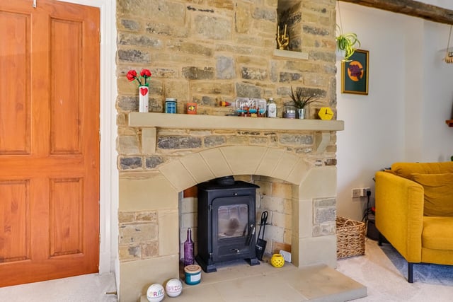 This attractive stone fireplace with stove would be a focal point in any room.