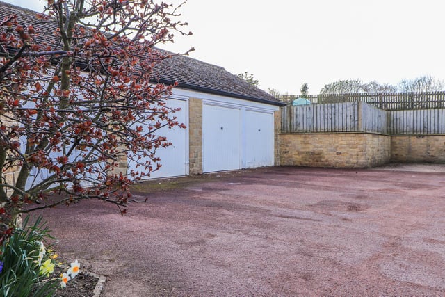 Parking spaces for vehicles are provided along with a garage with this property sale.