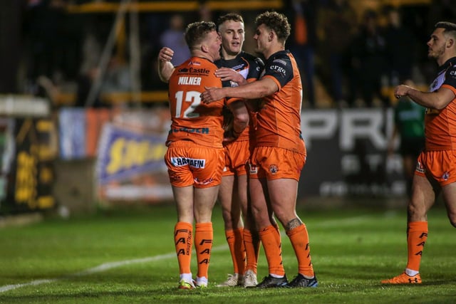 Adam Milner celebrates his try with teammates Jake Trueman and George Lawler. Picture: Simon Hall