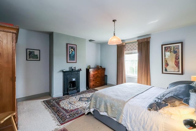 A period fireplace is one feature of this double size bedroom.