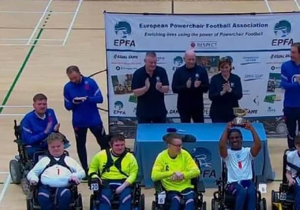 The England Powerchair Football team, including Dan Rigby, from Wakefield, celebrate winning the Home Nations Cup.