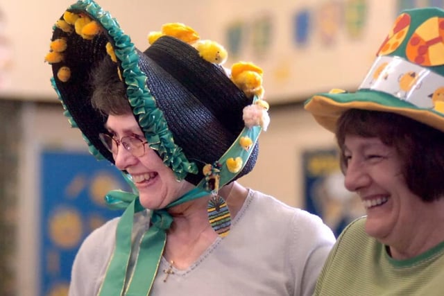 Deputy Head Joyce Woodall (left) joins in the fun of the Easter bonnet parade and concert at All Saints Infant School.
