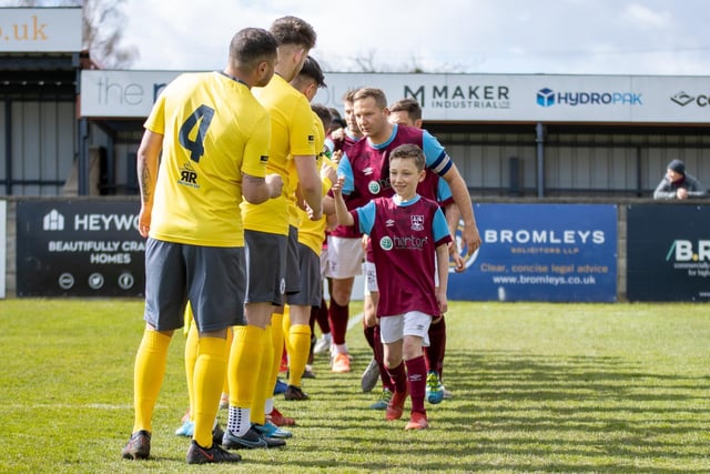 Handshakes before the kick-off with Emley AFC's mascot for the day leading the way.