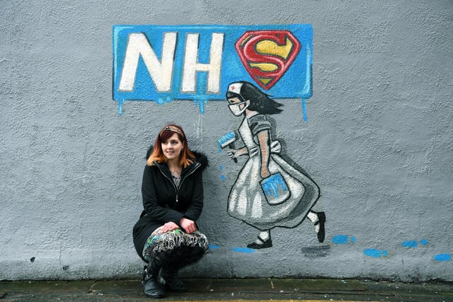 Rachel List with one of her murals celebrating the work of the NHS during Covid.