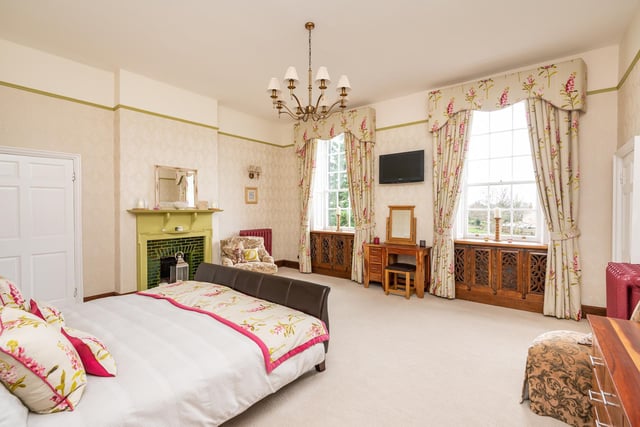 This double bedroom features super size windows, and has a period fireplace.