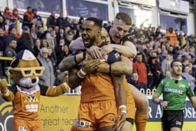 Castleford Tigers' young winger Jason Qareqare celebrates his first minute try against St Helens with Mahe Fonua and Jake Trueman. Picture: Allan McKenzie/SWpix.com