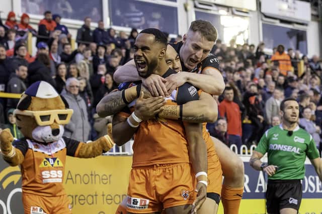 Castleford Tigers' young winger Jason Qareqare celebrates his first minute try against St Helens with Mahe Fonua and Jake Trueman. Picture: Allan McKenzie/SWpix.com
