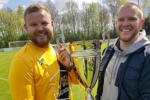 Kirklands captain Chris Wilde was presented with the Premiership Two League Cup by W&DSFL's guest of honour Brett Mercer.