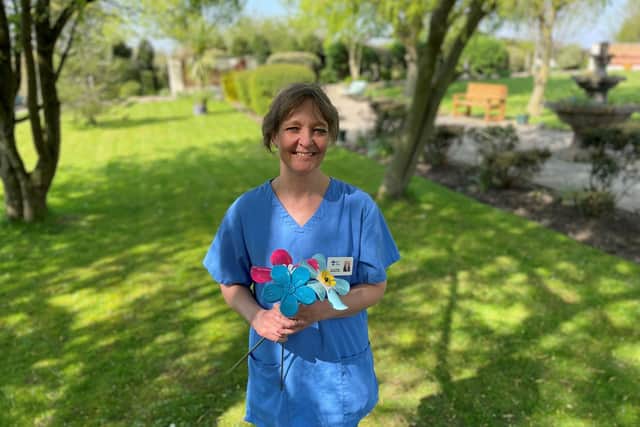 A nurse at Wakefield Hospice with one of the Forget Me Not flowers