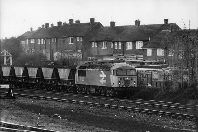 A coal train shunts past homes in the Hill Top estate, Knottingley, 1989.