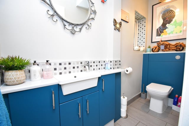 Fitted vanity unit storage around the wash basin in this stylish bathroom.
