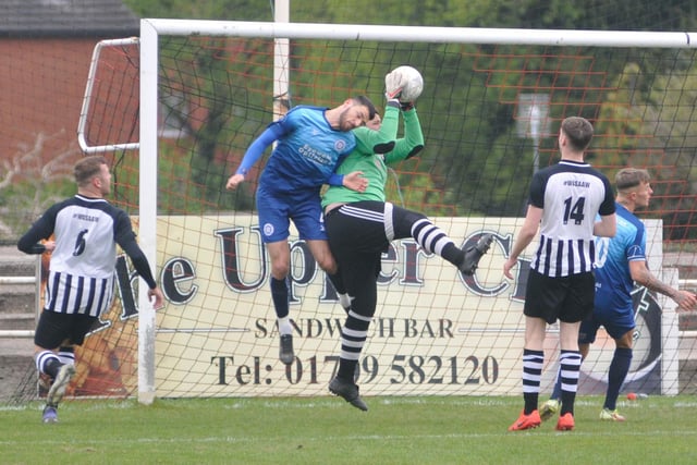Jock Curran challenges the Swinton goalkeeper for a high ball into the box.