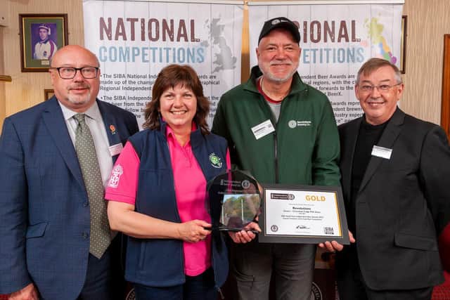 Revolutions Brewing's Mark Seaman presented with the Overall Champion Award by Grahame Morris MP, Beth Eaton of award sponsor Charles Faram, and Ian Mearns MP.