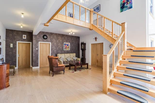 The spacious hallway and feature staircase in an all together stunning interior.