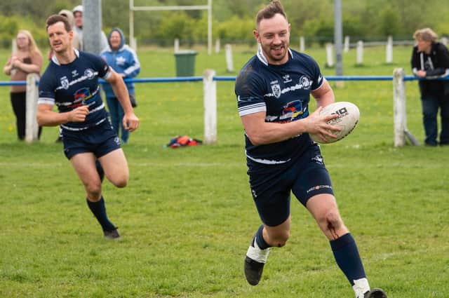 All smiles for Jake Perkins as he goes over for his hat-trick for Featherstone Lions with Davi Garahan in support. Picture: Jonathan Buck