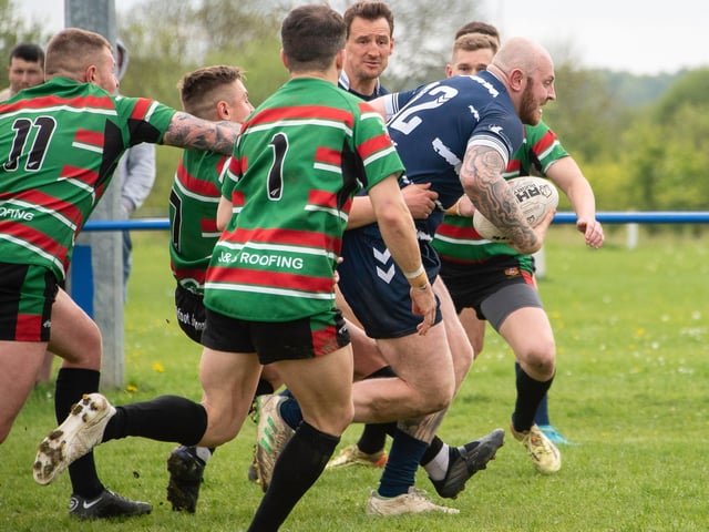 Sam Millard charges for the line with West Bowling defenders in pursuit. Picture: Jonathan Buck