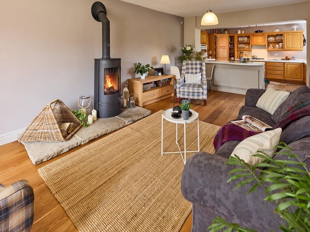 The open plan element links this seating area with the farmhouse style kitchen.