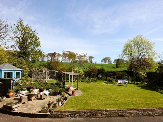Looking out over the garden, with fields and trees beyond.