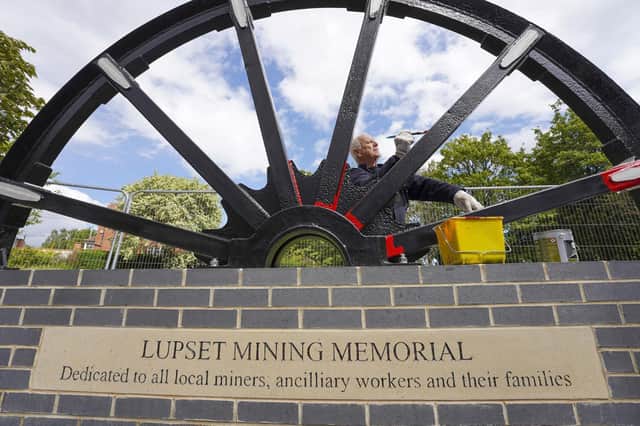 Eric Page paints the new memorial pit wheel at Flanshaw.