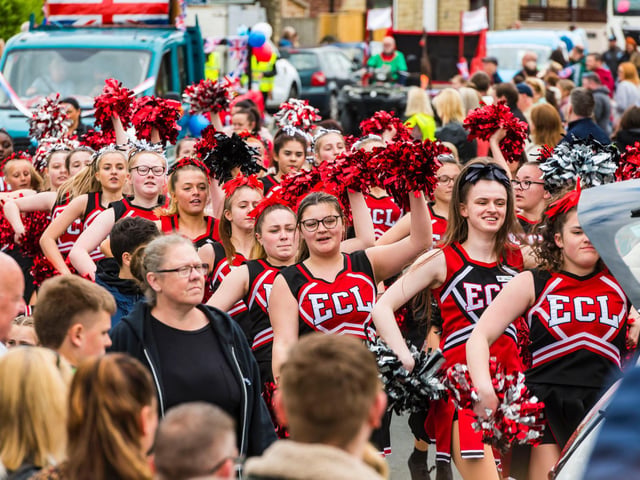Elite Cheerleaders, resplendent in black and red.