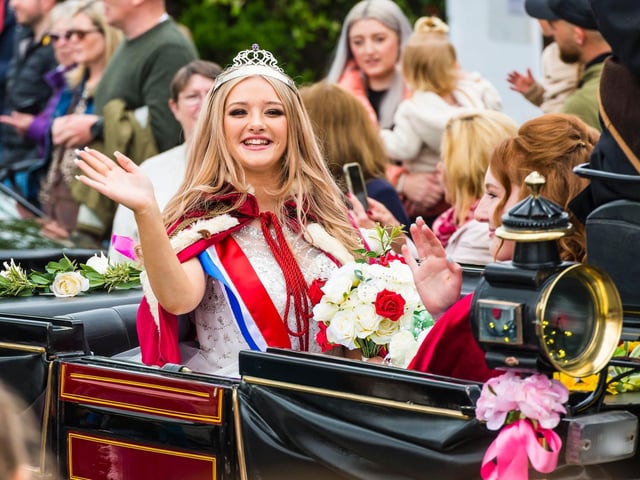 May Queen Mia Turton waves to the crowds.