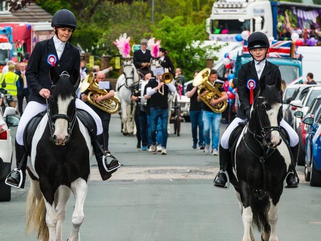 The outriders lead the procession.