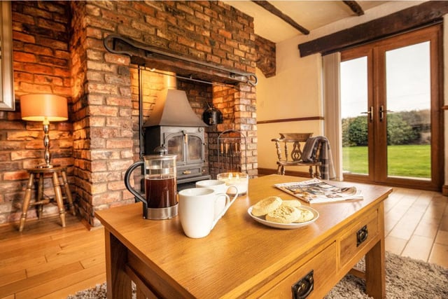 A solid fuel stove within an exposed chimney breast is a warming feature of this room.