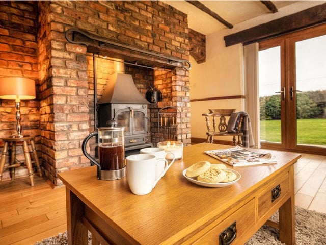 A solid fuel stove within an exposed chimney breast is a warming feature of this room.
