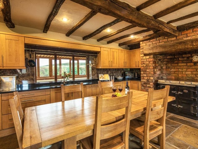 This hub features a Yorkshire stone floor, a beamed ceiling and an inglenook fireplace with inset Everhot stove.​