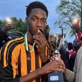 Wakefield Athletic captain Bubacarr Camara (left) is presented with his medal and the Soni Friendship Cup by the sponsor of the tournament, Muhamed Tunkara, Soni Transfer CEO, Birmingham.